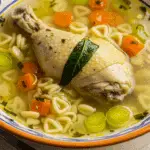 Bouillon de poulet doré maison dans bol traditionnel vapeur montante