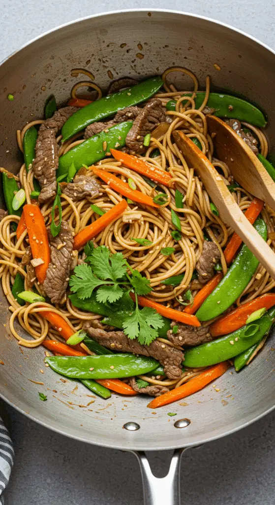 Wok de légumes au bœuf avec nouilles chinoises dans un wok traditionnel noir