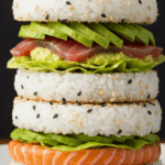 Sushi géant style burger coupé en deux montrant toutes les couches colorées