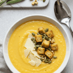 Soupe de céleri-rave et carotte veloutée avec granola salé croustillant et copeaux de parmesan