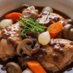 Coq au vin traditionnel bourguignon sauce vineuse profonde authentique